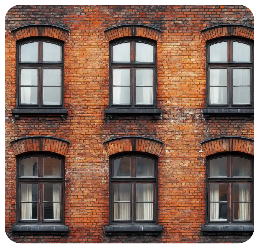 Red brick building facade with symmetrical arched windows