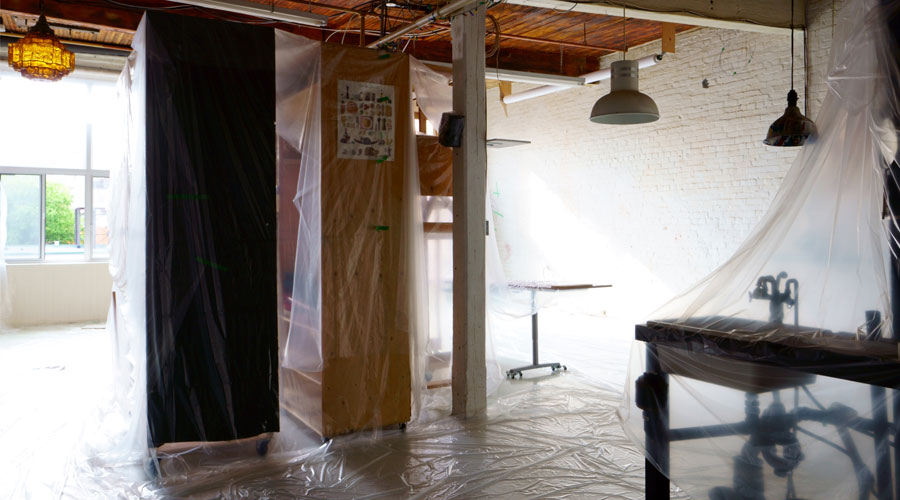 Construction containment barriers and plastic sheeting installed inside a commercial space during renovation work, a common situation where indoor air quality testing may be performed to evaluate airborne dust and particulate matter.