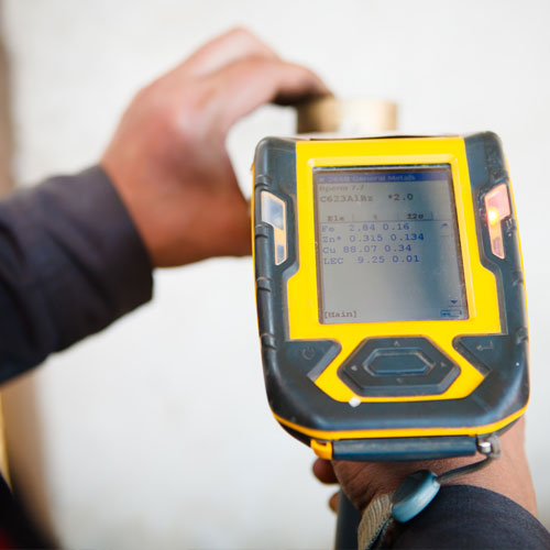 Inspector using an X-Ray Fluorescence (XRF) analyzer to perform lead paint testing under Local Law 31 requirements in New York City