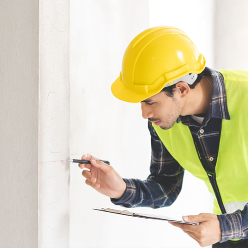EPA-certified renovator inspecting painted surfaces before performing lead-safe work under the EPA Renovation, Repair and Painting (RRP) Rule