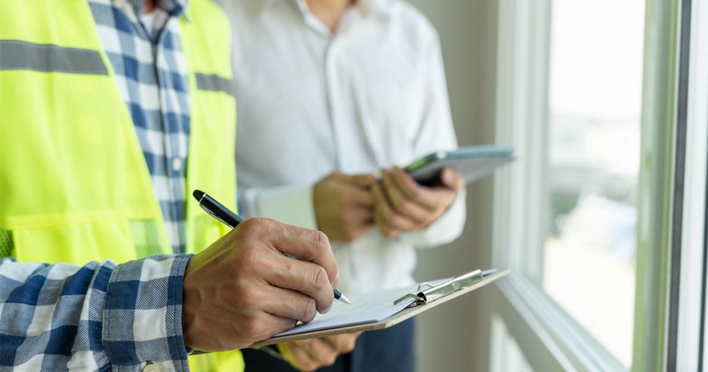 Environmental inspector documenting a lead paint inspection in a New York City apartment during an HPD or DOH lead violation assessment