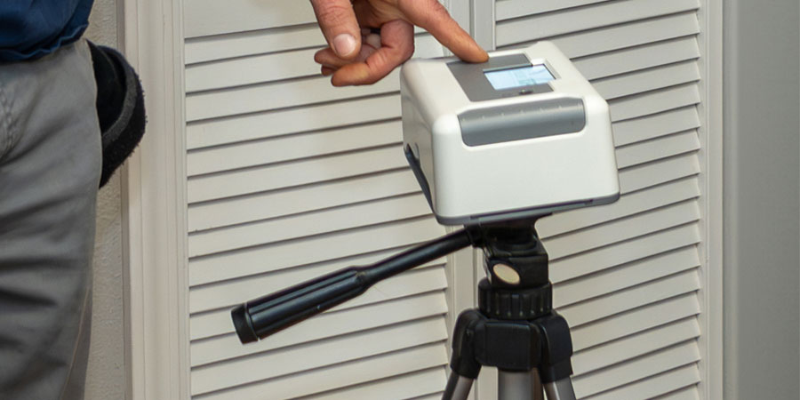 Professional radon testing device measuring indoor radon levels during a residential home inspection